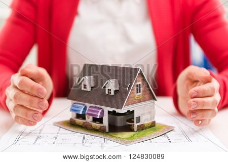 House agent offering new real estate to customer in the office.