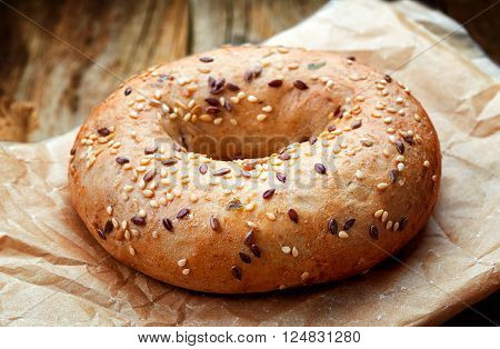 Fullgrain Bagel With Seeds On Wooden Table