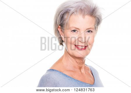 Smiling senior woman in front of white background