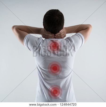 Spinal cord problem. Closeup of male back with red points on spine. Physiotherapy concept.