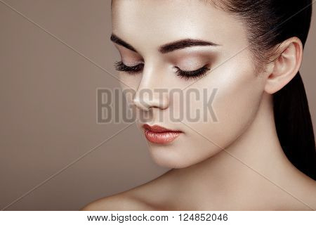 Beautiful woman face. Perfect makeup. Beauty fashion. Eyelashes. Cosmetic Eyeshadow. Highlighting