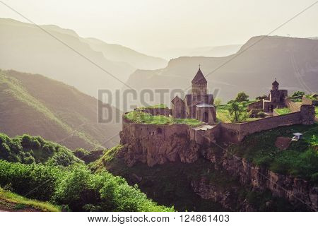 Ancient monastery in setting sun. Tatev. Armenia