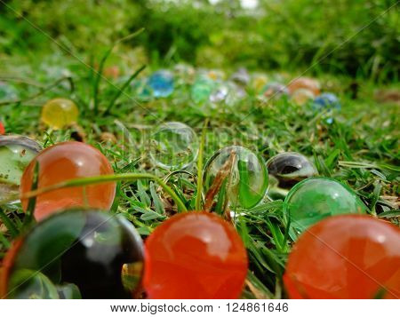 Magic balls looking like bubbles or marbles lying on grassland.