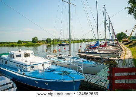 View on moored sailboats on river in Silute Lithuania in sunlight