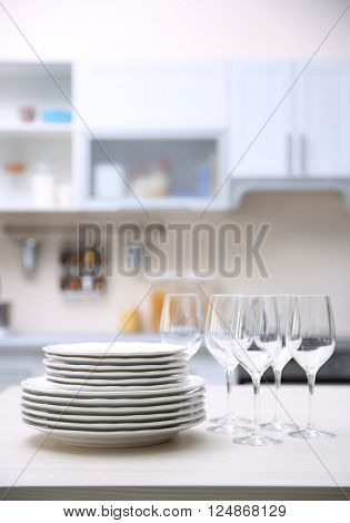 Prepared clean dishes for dinner party on a table in the kitchen