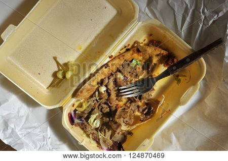 Left over remains of doner kebab take away food from the night before.