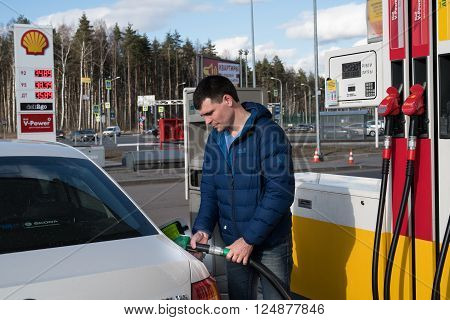 Saint-Petersburg Russia - April 7 2016: A man 30-35 years fills his car with petrol at a petrol station Shell