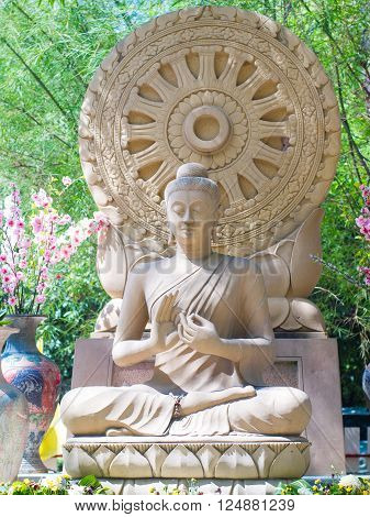 Sandstone Buddha image sitting front Dharmacakra .