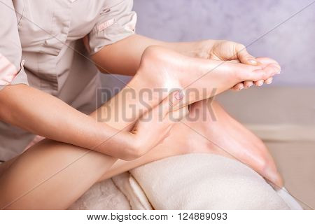 Closeup of feet Caucasian woman having a massage spa salon