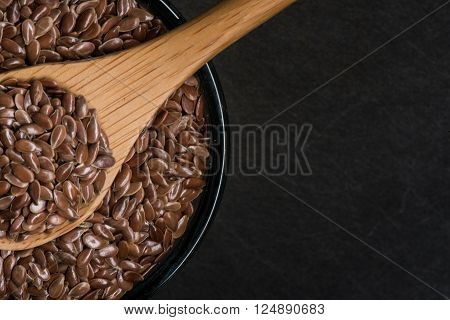 Wooden Spoon In Bowl Of Brown Flax Seeds
