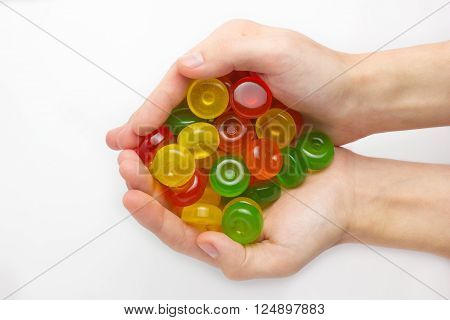candies in the hand. On white background. multi color isolated