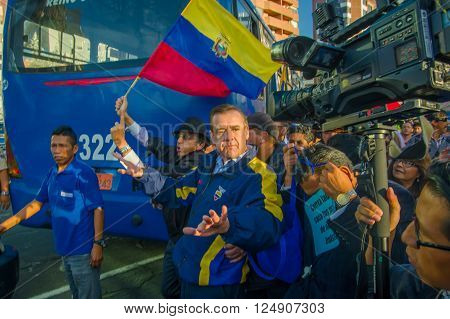Quito, Ecuador - April 7, 2016: Closeup opposition leader Andres Paez surrounded by people, police and journalists during anti government protests in Shyris Avenue.