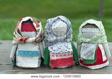 Russian traditional rag doll on nature background