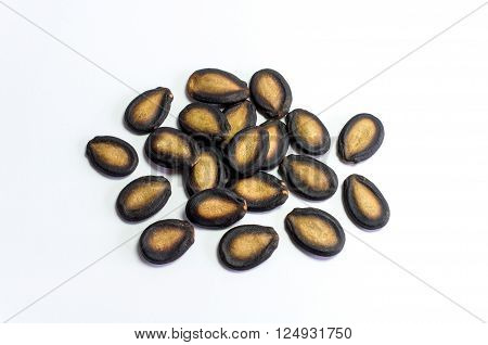 Watermelon seeds on white background, row shape