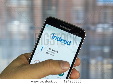 MONTREAL CANADA - APRIL 7 2016 : Indeed job search application on a cell phone. Indeed is a global online employment solution for people seeking jobs.