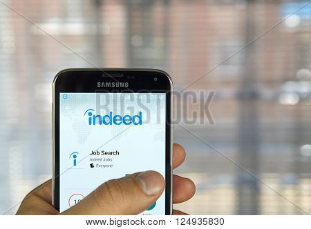 MONTREAL CANADA - APRIL 7 2016 : Indeed job search application on a cell phone. Indeed is a global online employment solution for people seeking jobs.