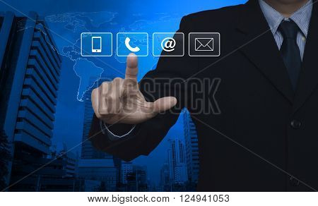 Businessman pressing telephone mobile phone at and email buttons over map and city tower Customer support concept Elements of this image furnished by NASA