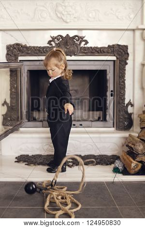 Girl as a chimney sweep against fireplace. Lucky New Year's Eve and New Year.