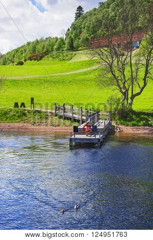 Pier in Loch Ness in Scotland. Loch Ness is a city in the Highlands in Scotland in the United Kingdom.