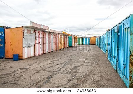 multicolored garages in the industrial area under cloudy sky