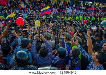 Quito, Ecuador - April 7, 2016: Group of people Holding protest signs, police and journalists during anti government protests in Shyris Avenue.