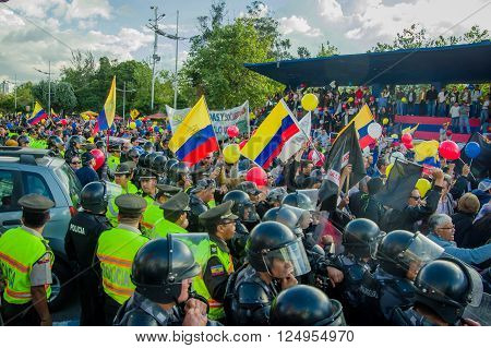 Quito, Ecuador - April 7, 2016: Police awaiting overlooking peaceful anti government protests in Shyris Avenue, beautiful blue sky and buildings background.