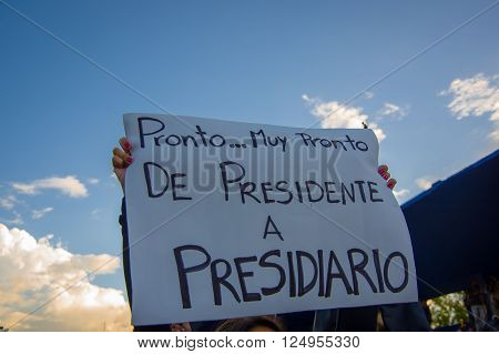 Quito, Ecuador - April 7, 2016: Group of people Holding protest signs, police and journalists during anti government protests in Shyris Avenue.