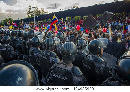 Quito, Ecuador - April 7, 2016: Police awaiting overlooking peaceful anti government protests in Shyris Avenue, beautiful blue sky and buildings background.