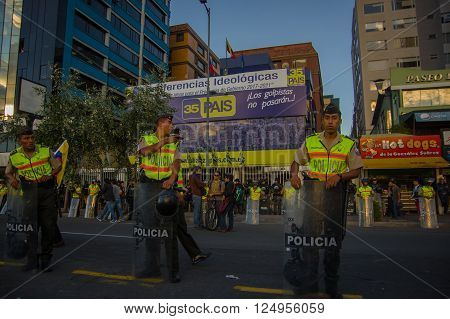 Quito, Ecuador - April 7, 2016: Police awaiting overlooking peaceful anti government protests in Shyris Avenue, beautiful blue sky and buildings background.