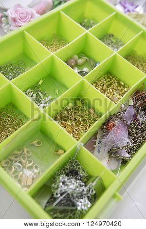 Accessories for needlework in container and tools for creating fashion jewelry in the manufacturing process. Jewelry Making. Workshop. Hobby - Bijouterie Modeling. Tools for Handmade