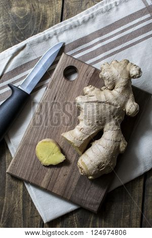 Fresh ginger root on a cutting board from above