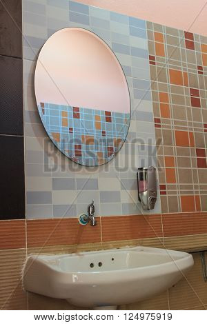 Bathroom at office.Handbasin and mirror in toilet