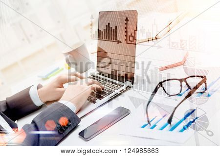Businessman typing on laptop glasses smartphone and cup aside. Only hands seen. Double exposure. Concept of work.