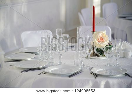 A festive table for a celebration. Banquet table with Cutlery and tableware. Table with white tablecloth served to guests. The table in the restaurant. Luxury Desk for the celebration.