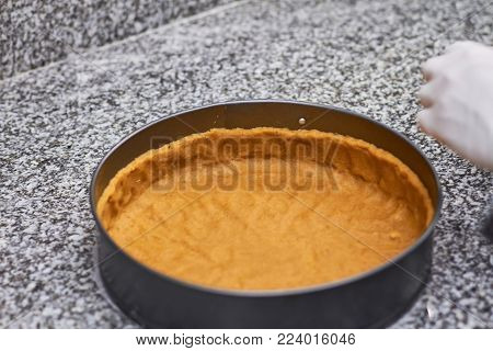 Pie crust in baking form. Round baking form for cake and pie crust inside. Cake base.