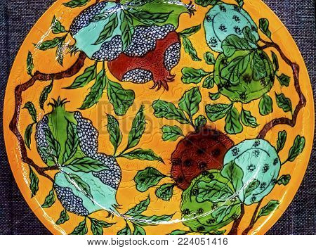 Old Chinese Design Yellow Green Ceramic Plate  Panjuan Flea Market  Beijing China. Panjuan Flea Curio market has many fakes, replicas and copies of older Chinese products, many ancient.