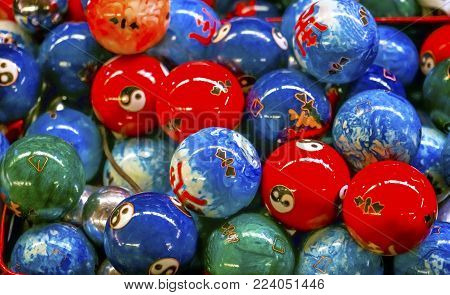 Chinese Replica Metal Buddhist Prayer Balls Decorations Panjuan Flea Market  Decorations Beijing China. Symbols on ball are Ying Yang, famous Buddhist saying on opposites. Panjuan Flea Curio market has many fakes, replicas and copies of older Chinese prod