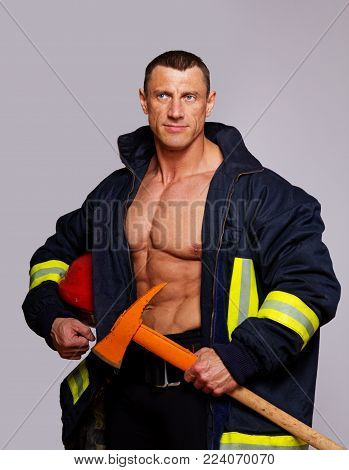 Portrait of muscle man posing in studio with hummel