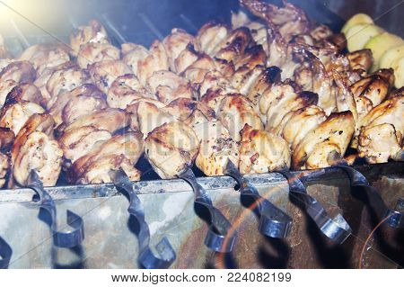 Marinated shashlik preparing on a barbecue grill over charcoal. Shashlik or Shish kebab popular in Eastern Europe