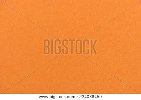 texture of orange color paper as background