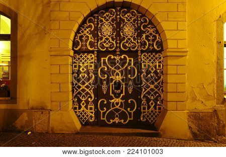 Old golden historic gate in a medieval city at night in Bautzen Saxony Germany Europe