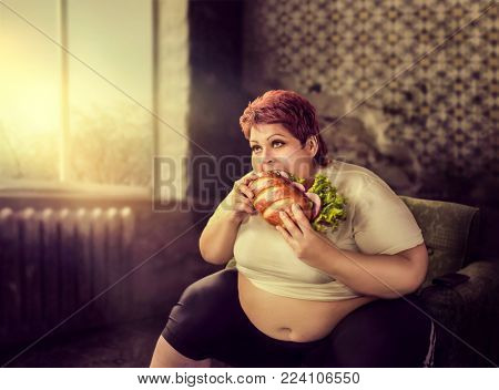 Overweight woman eats sandwich, bulimic