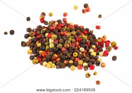 Black, red and white peppercorns isolated on white background. Heap of spice. Mix of different peppers.