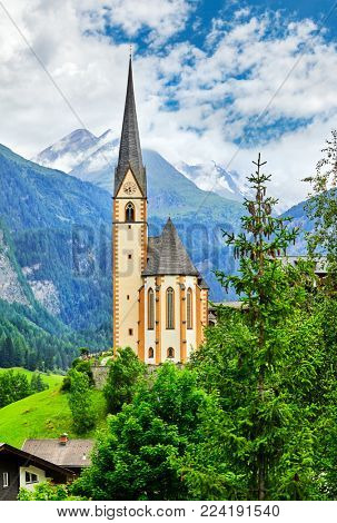 Heiligenblut Carinthia Austria picturesque landscape in mountain Alps with view at church chapel summery day blue sky and white cloud.
