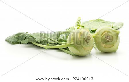 Two kohlrabi (German turnip or turnip cabbage) bulbs with fresh leaves isolated on white background