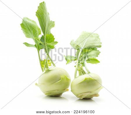 Kohlrabi (German turnip or turnip cabbage) with fresh leaves isolated on white background two raw bulbs