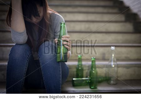 depressed woman feel upset with alcoholism problem and sit in underground road