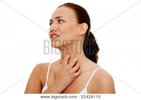Young beautiful woman scratching her self. Isolated on white