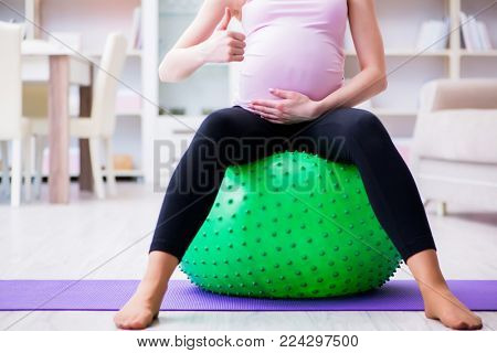 Pregnant woman exercising in anticipation of child birth