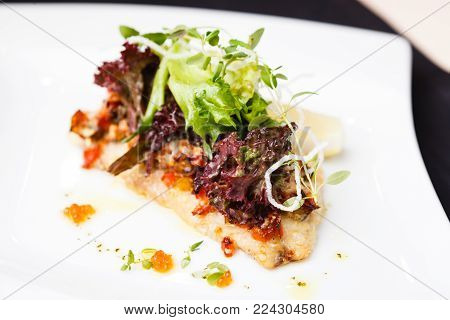 European bass branzino with spicy ratatouille and red caviar